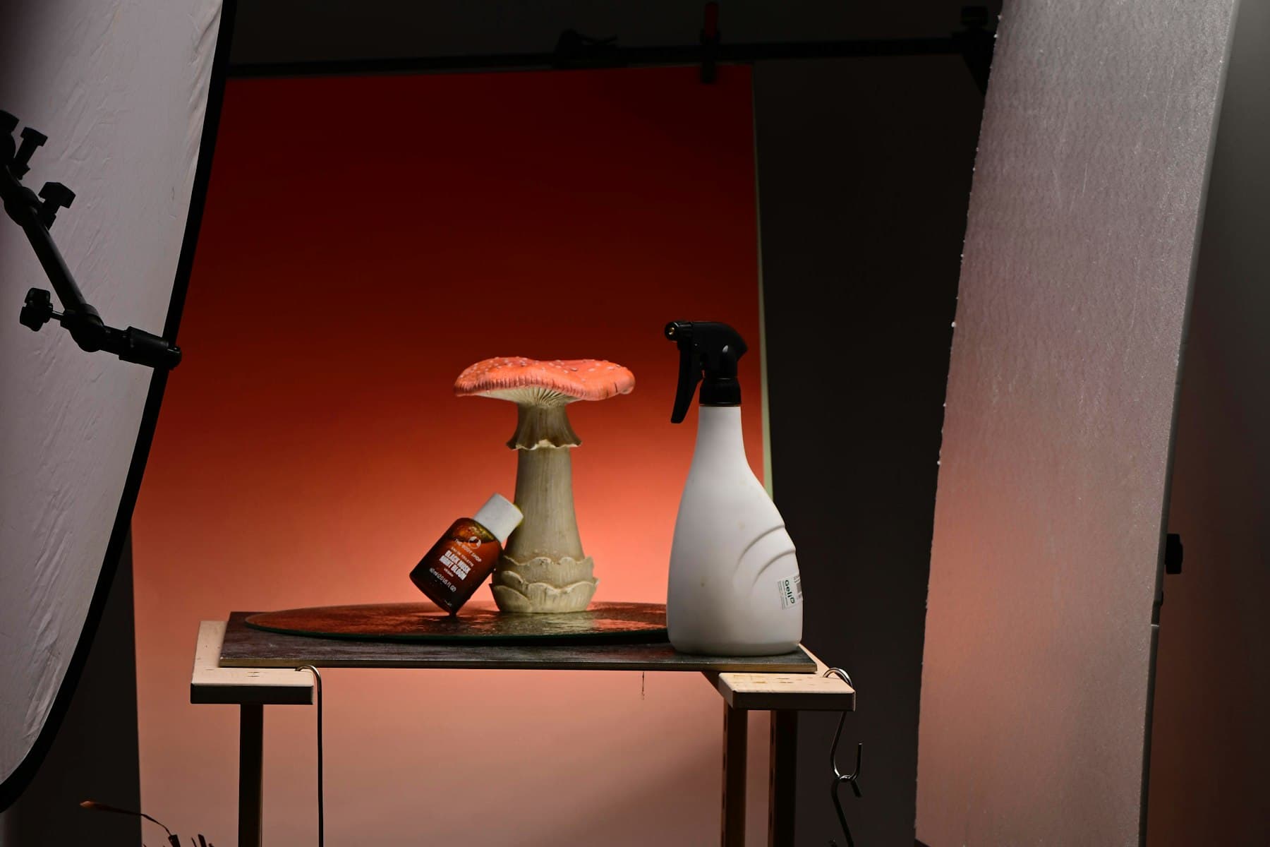 Products lit on a table against a backdrop during a product photography shoot.
